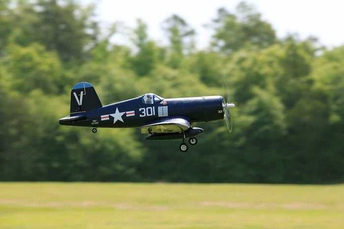 FMS 800mm F4U Corsair V2 RC airplane flying outdoors with detailed markings and landing gear.