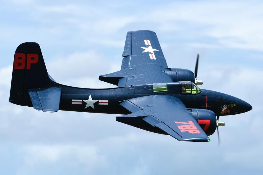 FMS 1700mm F7F Tigercat PNP model airplane in blue with red markings, flying in the sky.