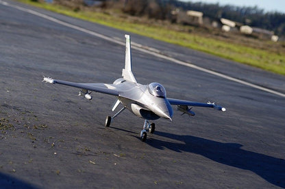 FMS 70mm F-16C Fighting Falcon RC jet model on tarmac, grey camouflage, ready for takeoff.