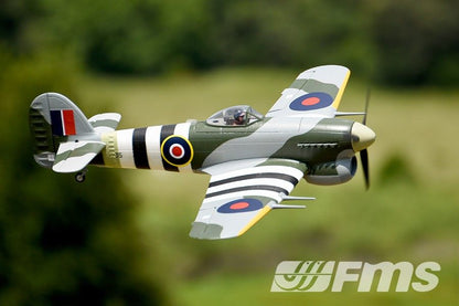 FMS 1100mm Hawker Typhoon PNP scale model aircraft in flight, featuring camouflage paint and British roundels.