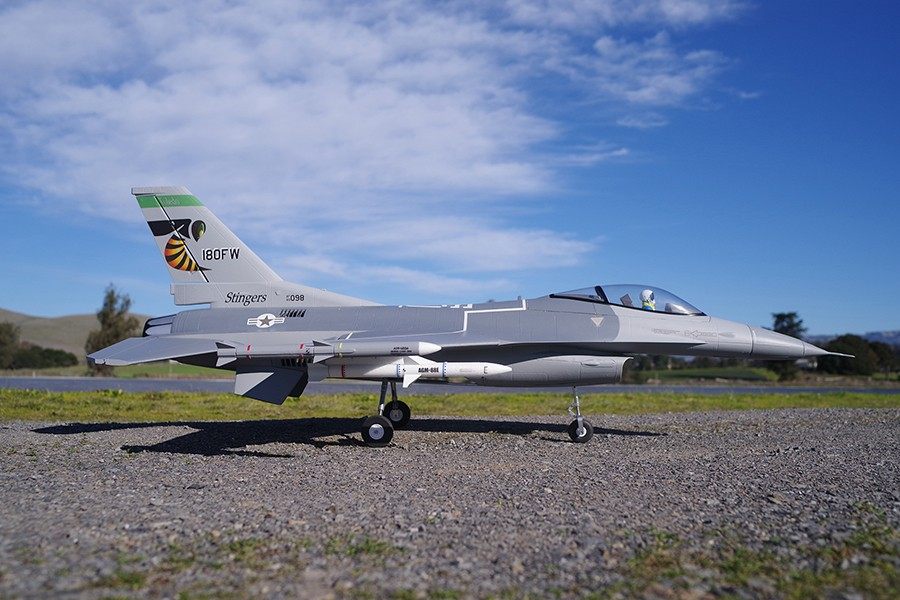 FMS 70mm F-16C Fighting Falcon model jet with grey camouflage, '180FW' tail marking, and missiles.