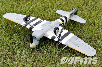 FMS 1100mm Hawker Typhoon PNP model aircraft with black and white stripes on wings, sitting on grass.