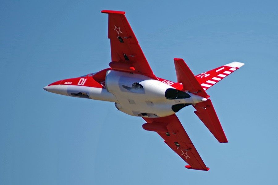 FMS Yak-130 V2 PNP jet in red and white, flying against a blue sky. Features prominent '01' and '130' markings.