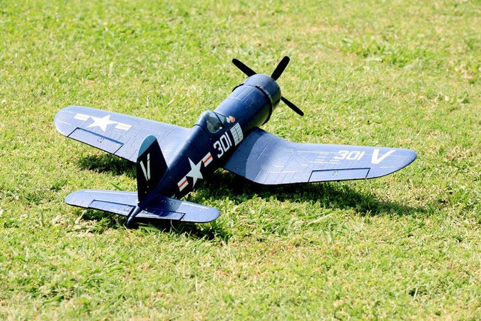 FMS 800mm F4U Corsair V2 RC airplane on grass, featuring '301' markings and US Navy insignia.