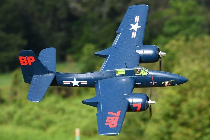 FMS 1700mm F7F Tigercat Blue PNP flying over a green landscape